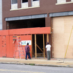 Workers removing signs announcing the pending arrival of New Vulcan Ale House. acnatta/Flickr